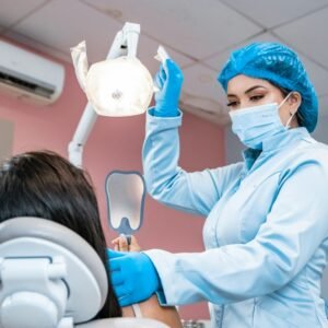 a woman getting her teeth checked by a dentist